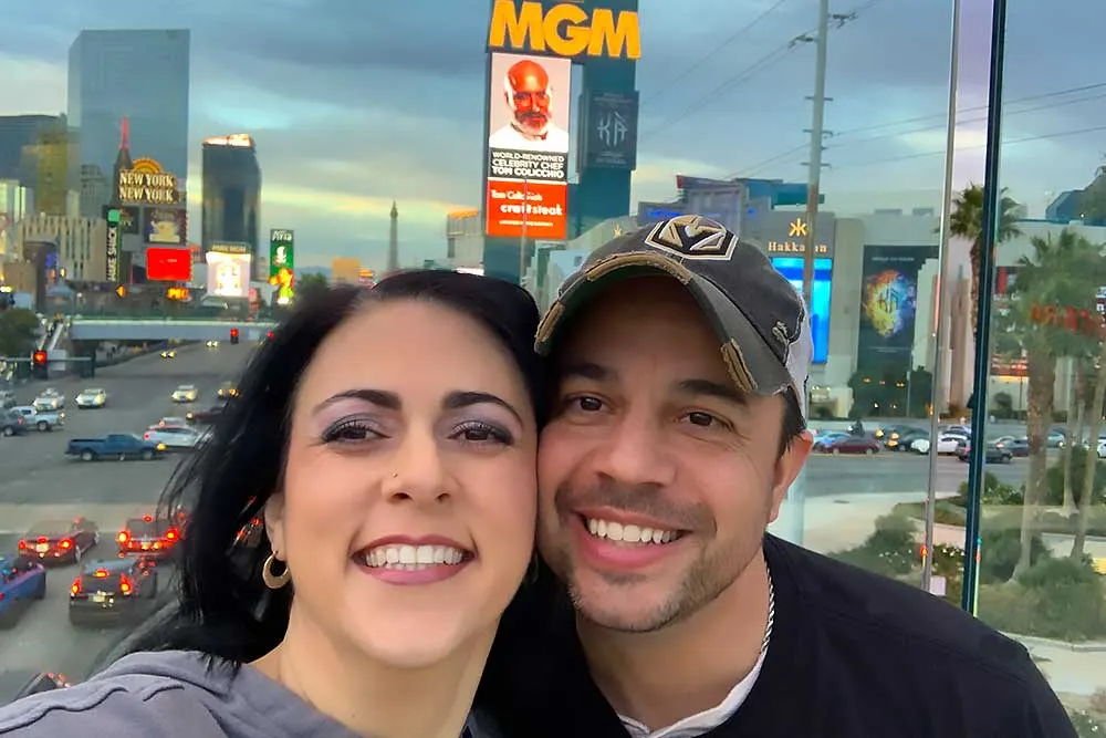 A couple smiling in front of the Las Vegas Strip, featuring bright lights and signs, symbolizing Crown Marketing's expertise in digital marketing services for enhancing brand visibility.| Crown Marketing Digital Marketing Agency Las Vegas