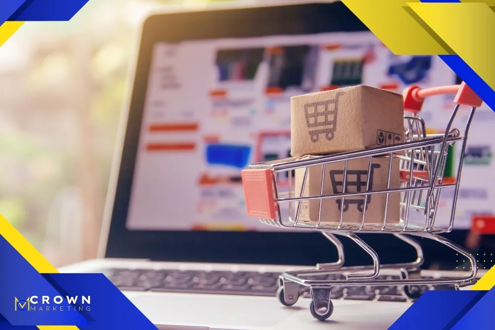 A miniature shopping cart with boxes sits on a laptop keyboard, representing Crown Marketing's digital marketing services for e-commerce in Las Vegas.| Crown Marketing Digital Marketing Agency Las Vegas